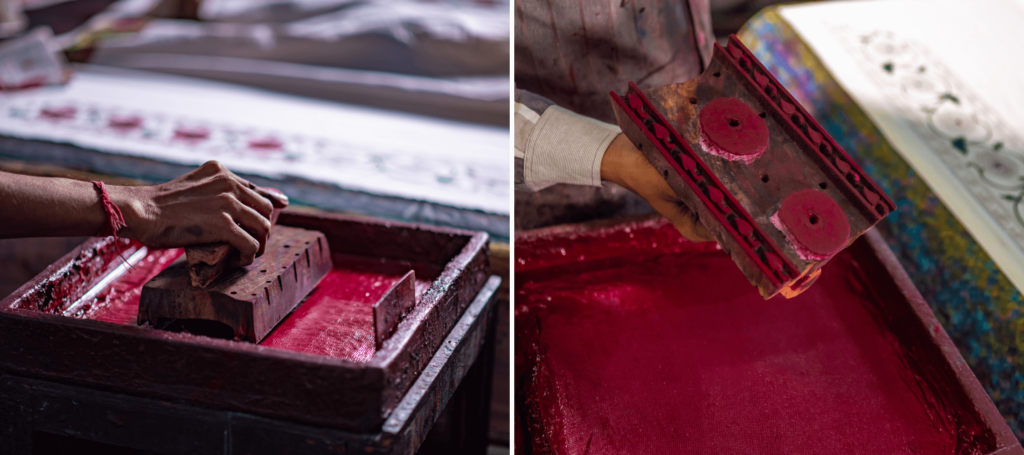 A carved wood block is dipped in a tray of natural plant dyes or man-made dyes in preparation for placing the block prints on fabric.