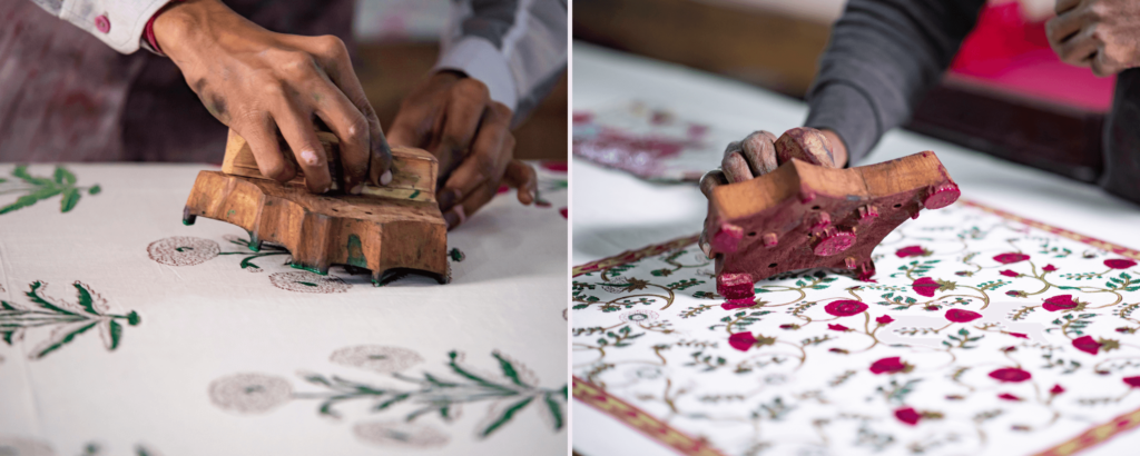 wood block designs are completely covered in dye and stamped in pattern across hand blocked fabric displayed upon a long table