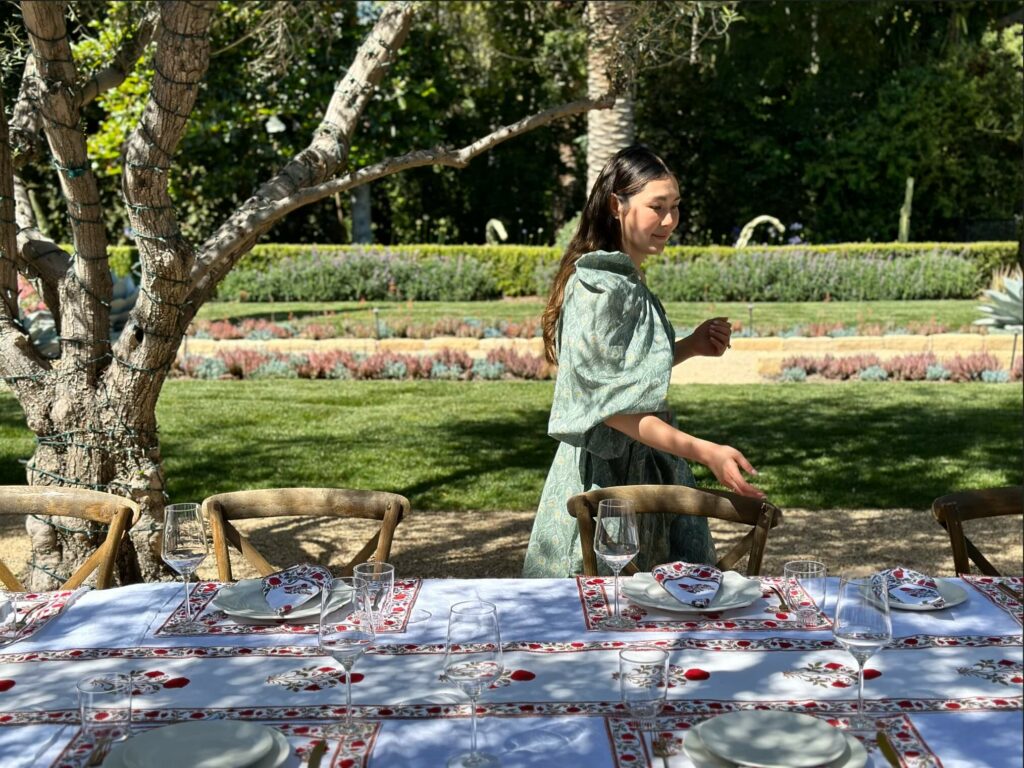Kate Kim Shah styling a chic tablescape with classic Indian design block print runners, placemats and cloth napkins from Marigold Living on the set of PBS' "Moveable Feast"