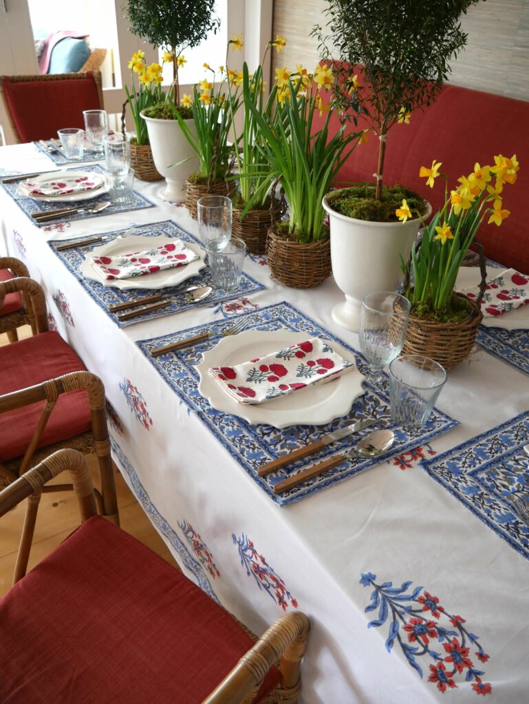 Dining Room with our Nargis block printed tablecloth, Anna placemats and Hana napkins in classic orange and blue, and red and blue floral prints, with Swedish mid-century modern dining furniture