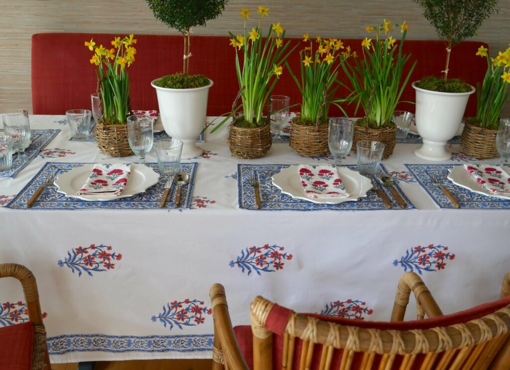 Dining Room with our Nargis block printed tablecloth, Anna placemats and Hana napkins in classic orange and blue, and red and blue floral prints, with Swedish mid-century modern dining furniture