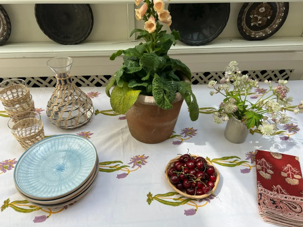 Summer end table setting with block print tablecloth and kalamkari napkins photographed from above